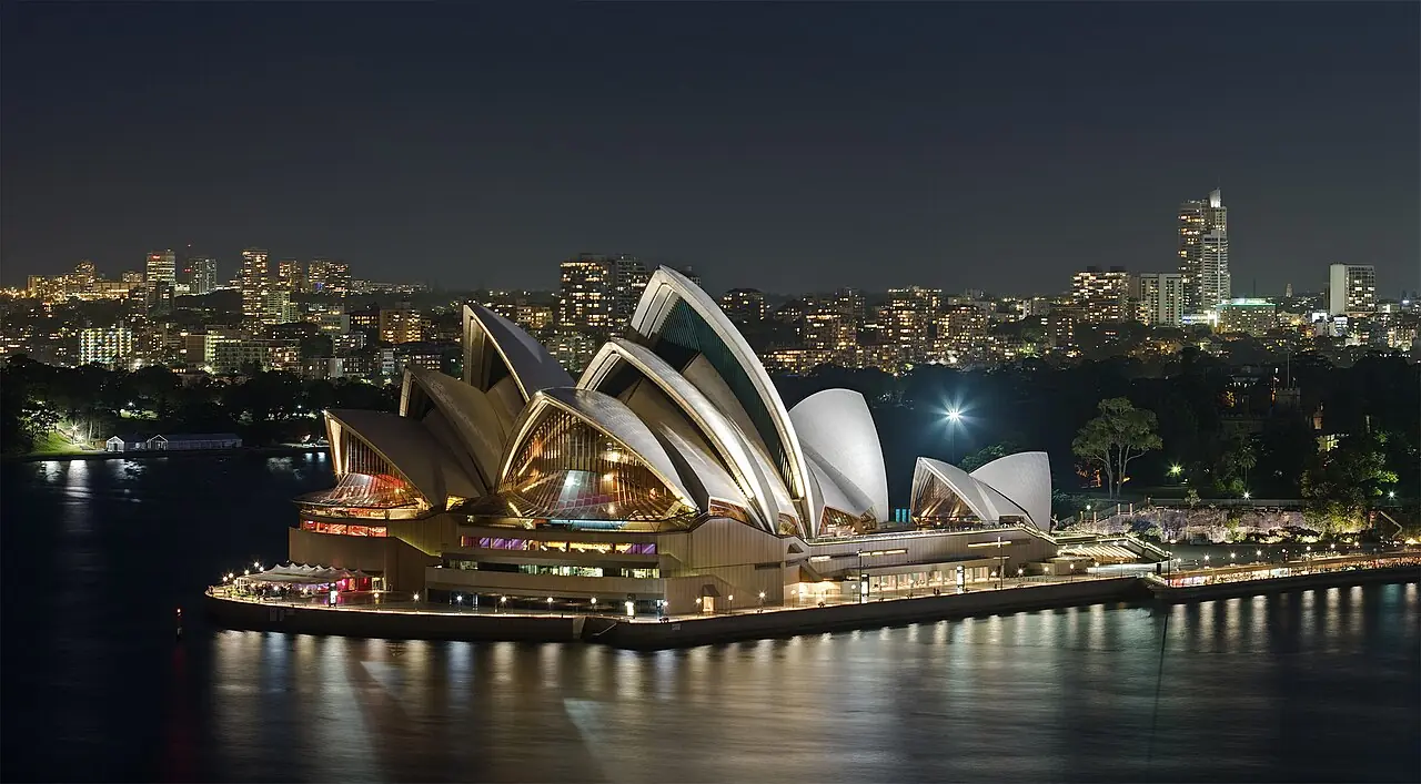 A exposure blended photo of the Sydney Opera House , as viewed from the Sydney Harbour Bridge . Taken by myself with a Canon 5D and 100mm f/