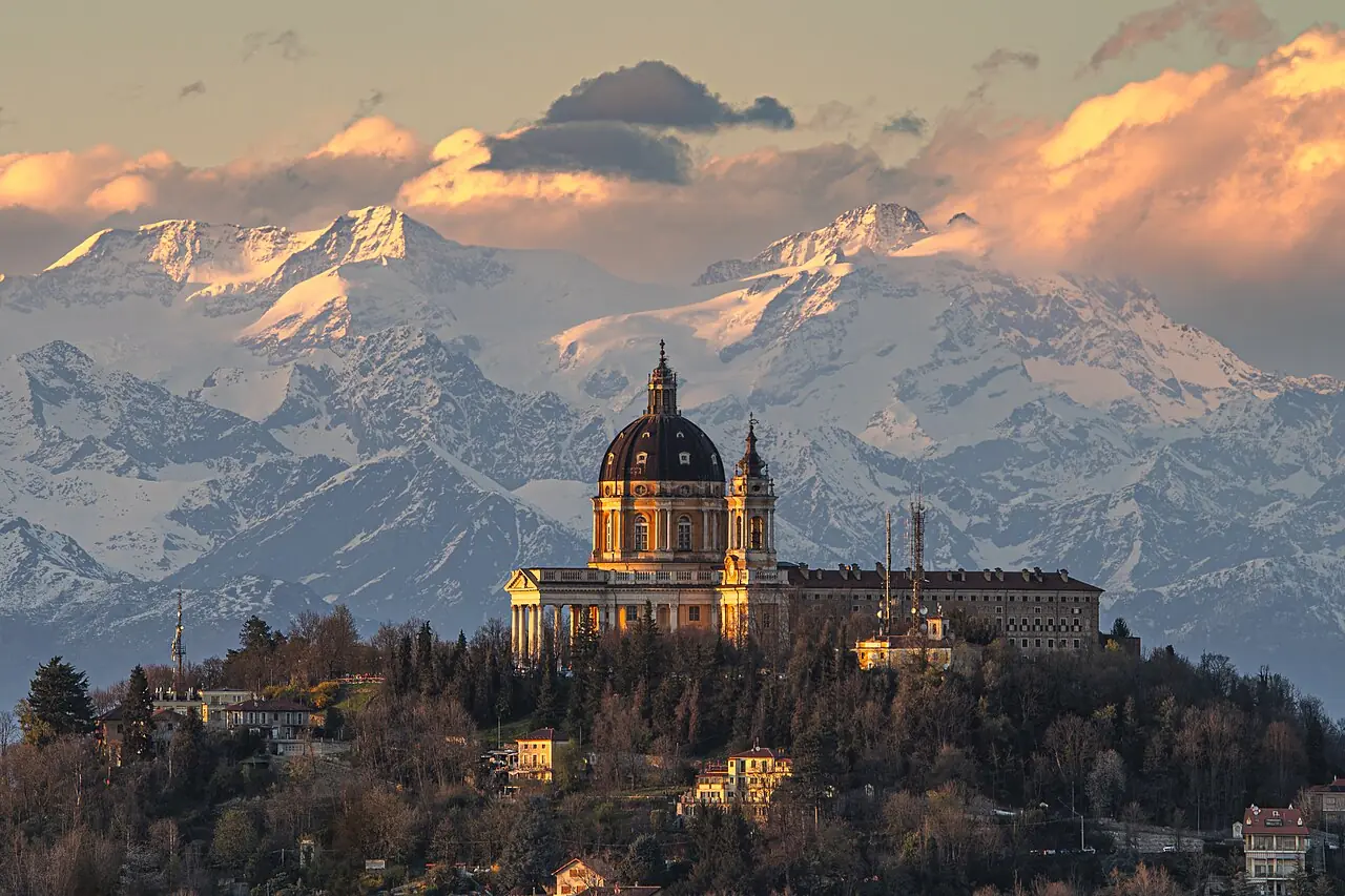 The Basilica of Superga and the Monte Rosa massif in the background at sunset. This hilltop basilica is located in the vicinity of Turin, Pi