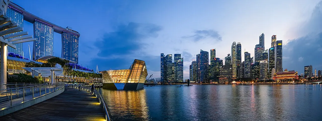 Singapore 's Marina Bay at Dusk in 2018. From left to right, Marina Bay Sands (MBS), Louis Vuitton store and the CBD.