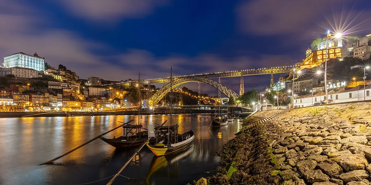 View during the blue hour of the Dom Luís I Bridge and the city of Porto , Portugal. The bridge, built between 1881 and 1886 spans the Douro